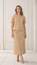 Front full view of woman wearing khaki short sleeve V-neck blouse and column maxi skirt set with gold buttons