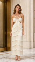 Front view of model wearing ivory tiered fringe cutout maxi dress with floral applique