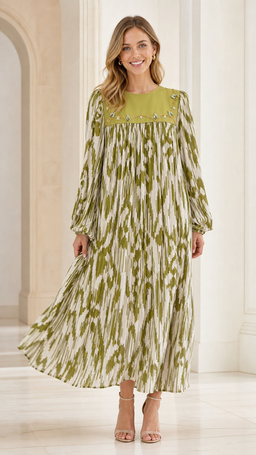 Woman wearing olive green pleated maxi dress with embroidered yoke - front view