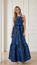 Front view of blue sleeveless brocade maxi dress with front bow