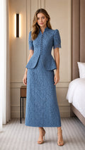 Front view of woman wearing blue lace peplum top and midi skirt with heels
