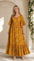 Front full-length view of model wearing mustard yellow floral lace-trimmed maxi dress