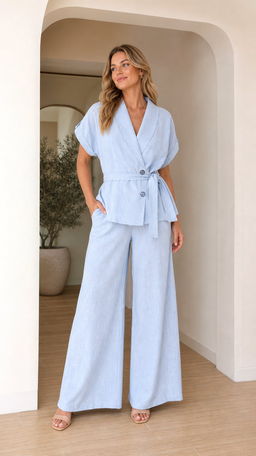 Front view of model wearing light blue two-piece blazer and wide leg pants set
