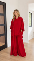 Red women's two-piece wide-leg pants set with collared dolman top, front view