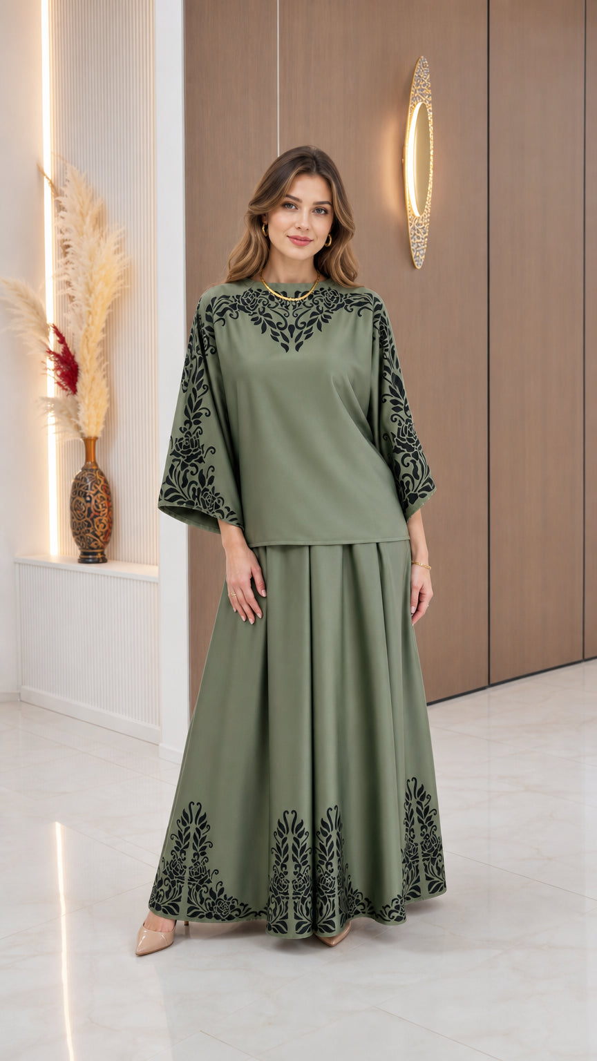 Front view of model wearing Sage Green modest two-piece top and maxi skirt set with black floral border print
