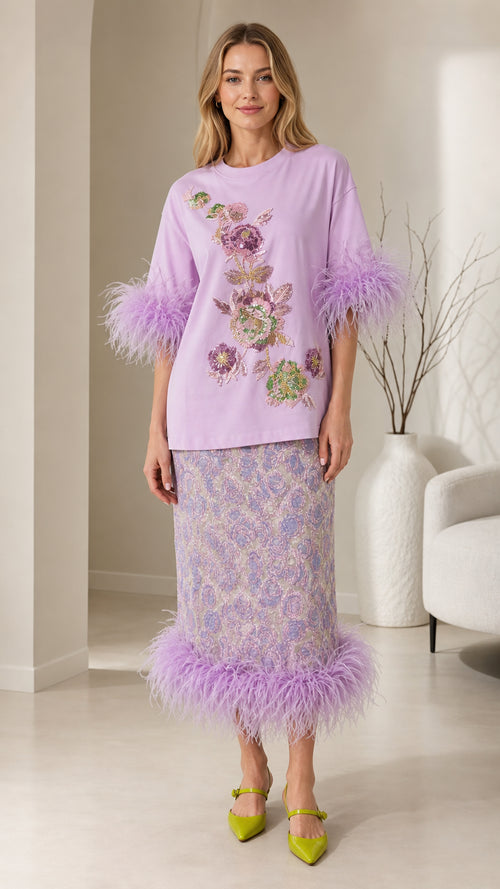 Front view of model wearing lavender feather trim top and midi skirt co-ord set