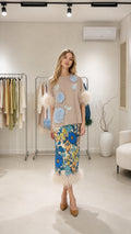 Model wearing beige two-piece set with floral appliques and feather trim from the front