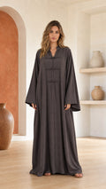 Front view of woman wearing dark grey long sleeve maxi dress