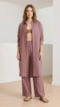 Woman wearing purple striped longline shirt and wide-leg pants front view