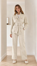 Front view of woman wearing beige utility jacket and wide-leg pants set