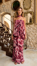 Front view of model wearing rose wine tie-dye strapless top and maxi skirt set