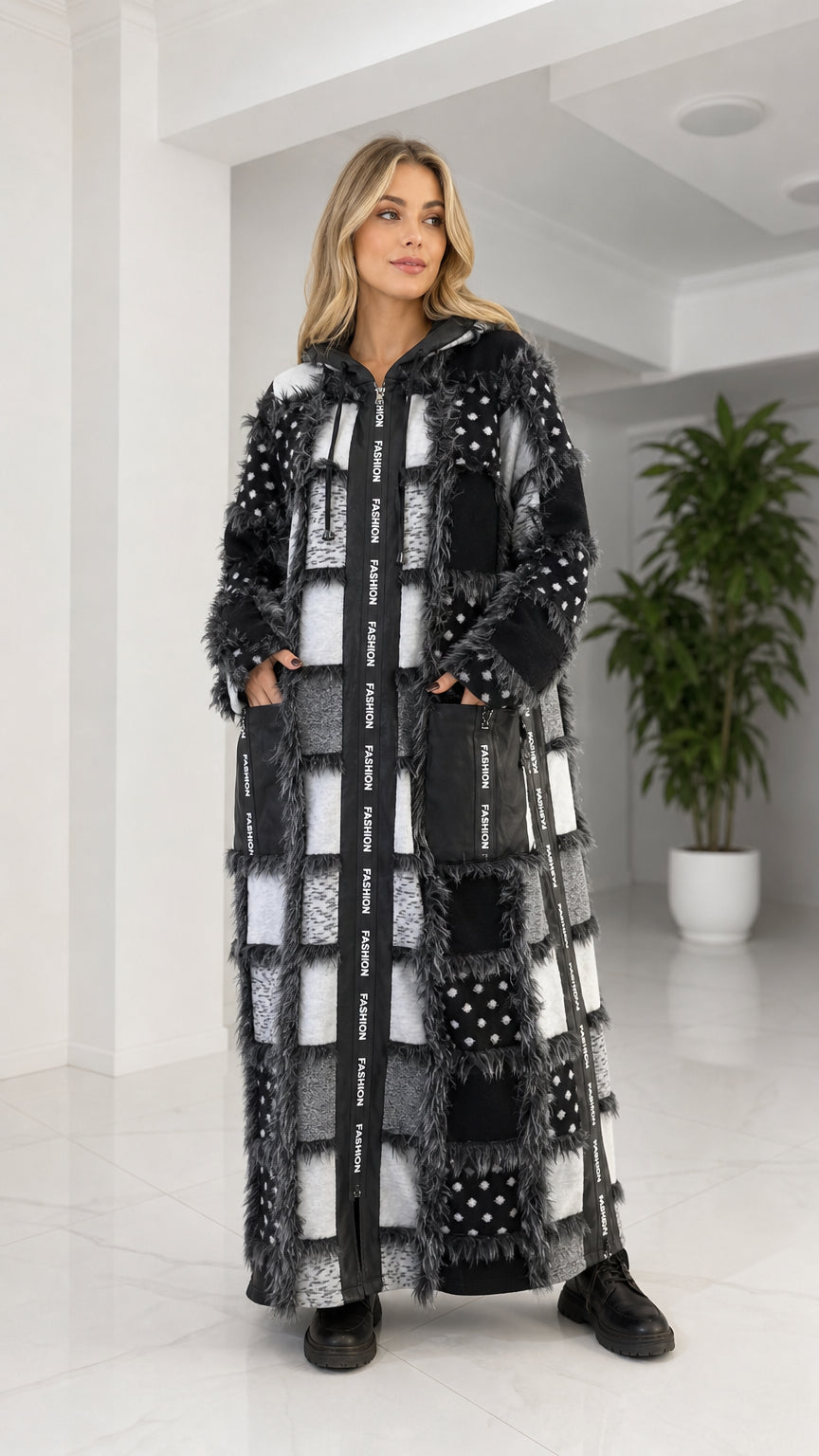 Front view of model wearing black patchwork faux fur long hooded coat