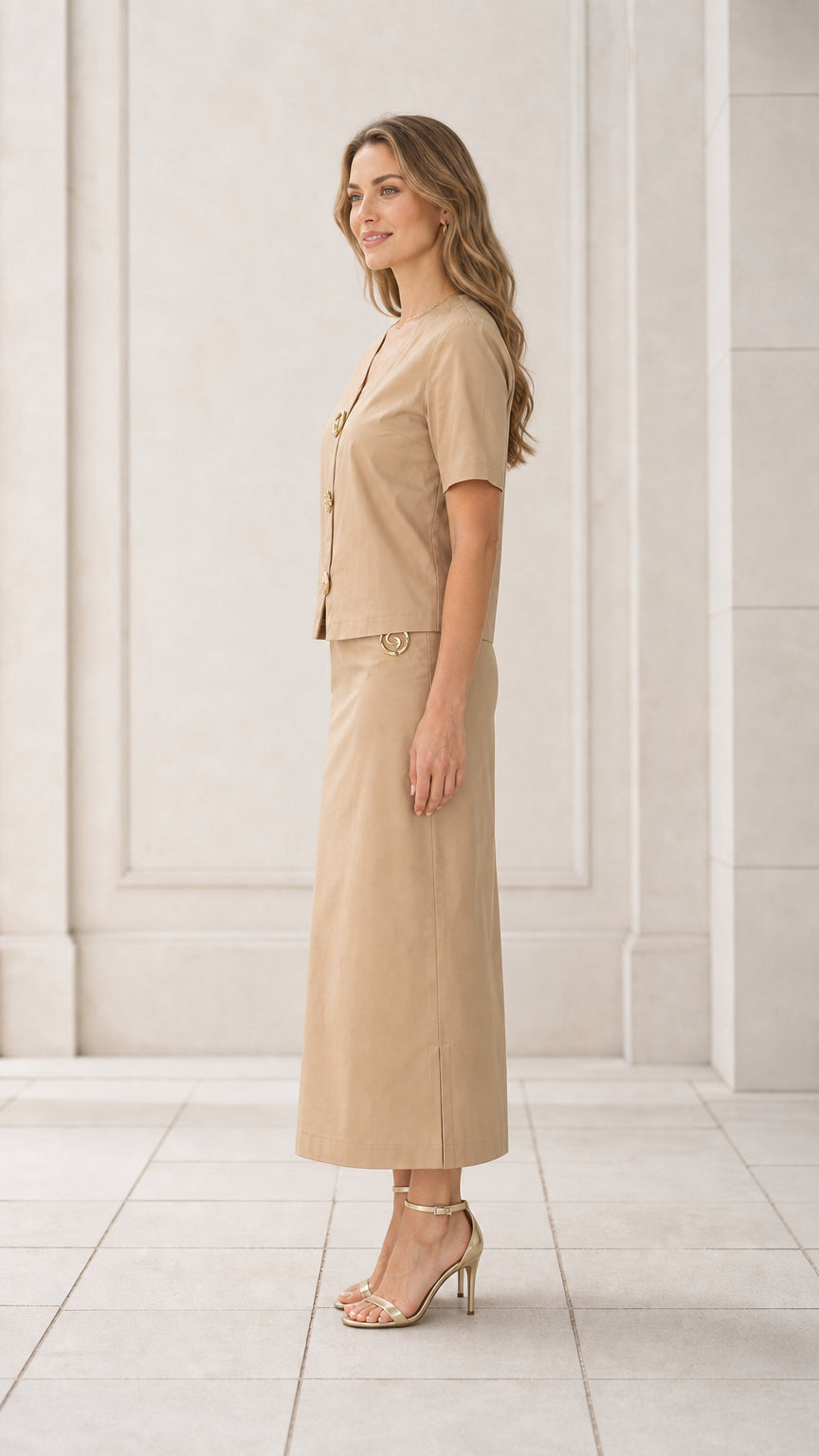 Side profile view of woman wearing khaki tailored two-piece maxi skirt set