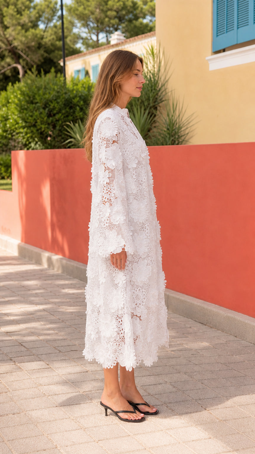 Side profile view of woman wearing white floral lace midi dress