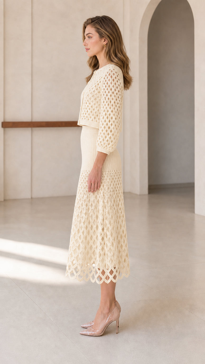 Side profile of model in cream knit two-piece set