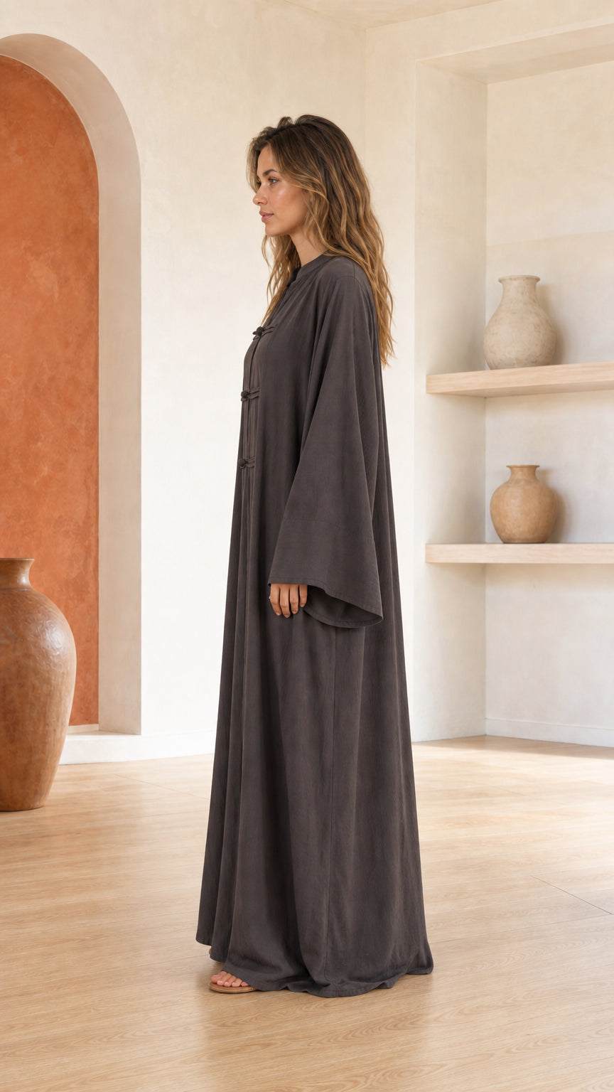 Side profile of woman in dark grey maxi dress