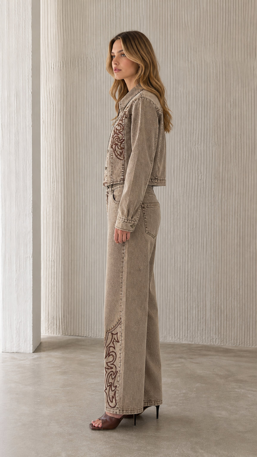 Side profile of model wearing khaki embroidered denim set