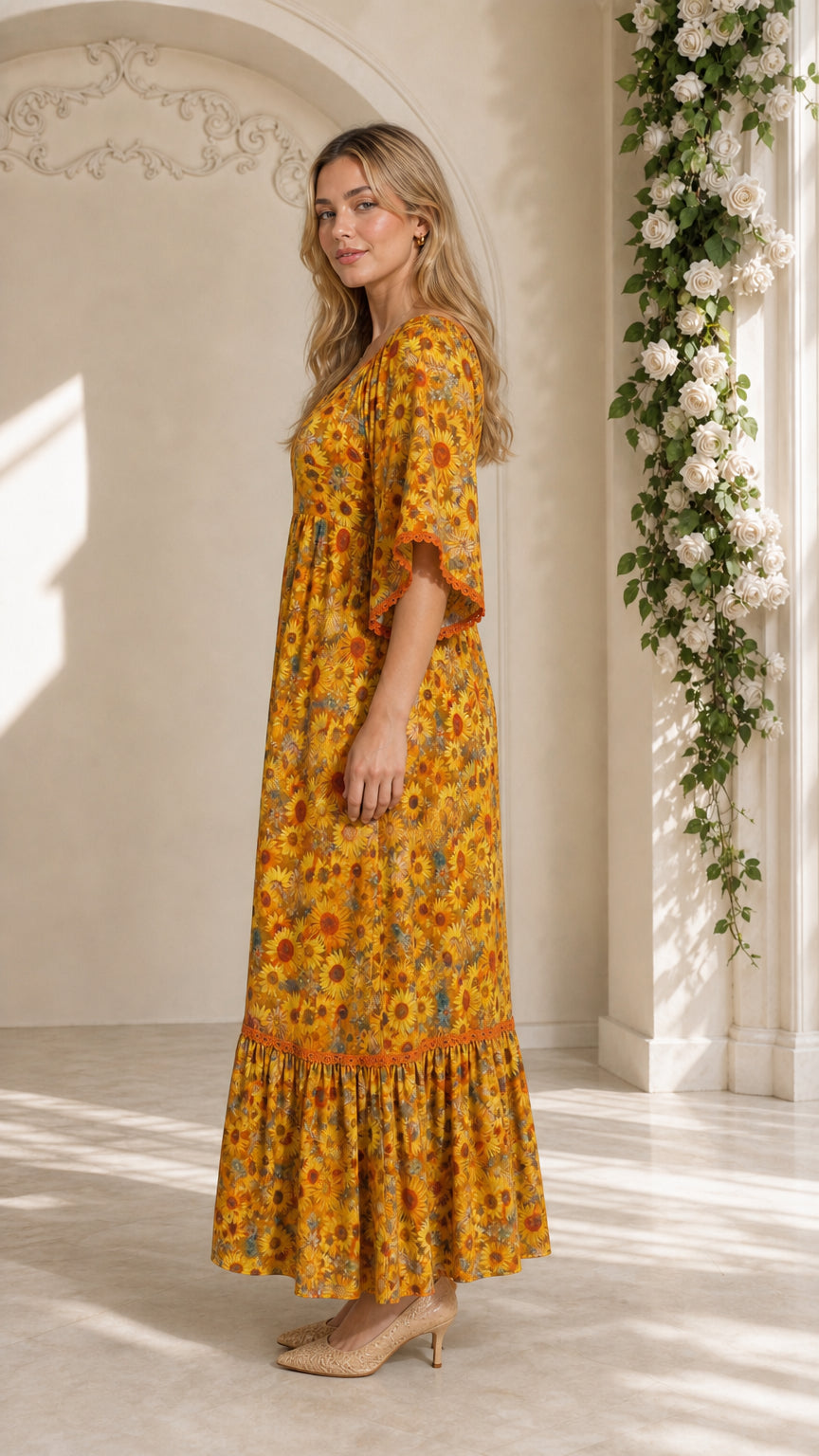 Side profile view of mustard yellow floral maxi dress showing flowing silhouette