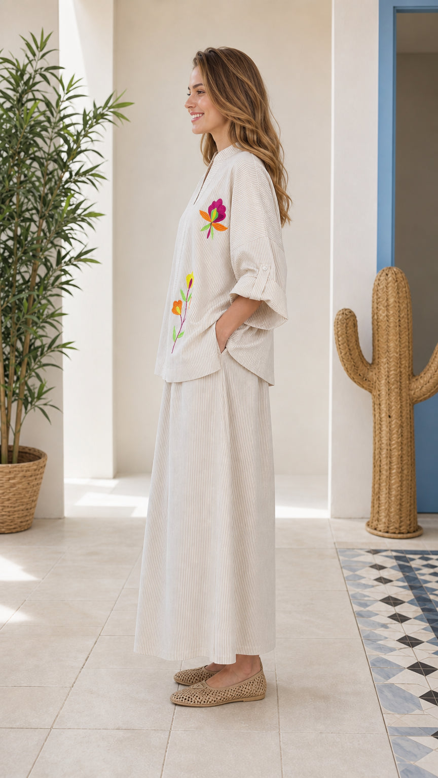 Side view of woman wearing beige embroidered two-piece set