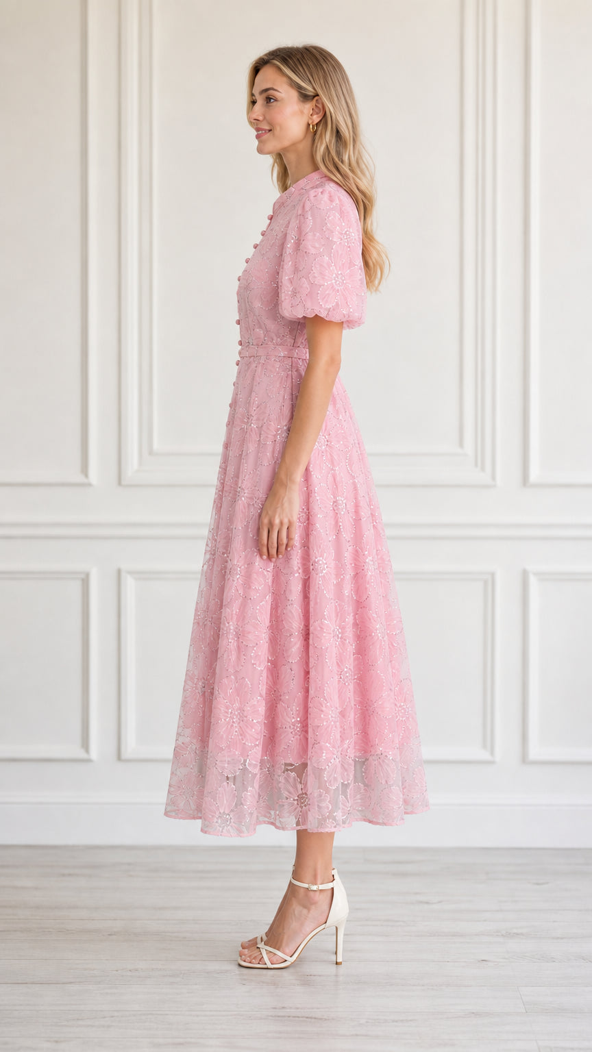 Side profile view of model in pink midi dress
