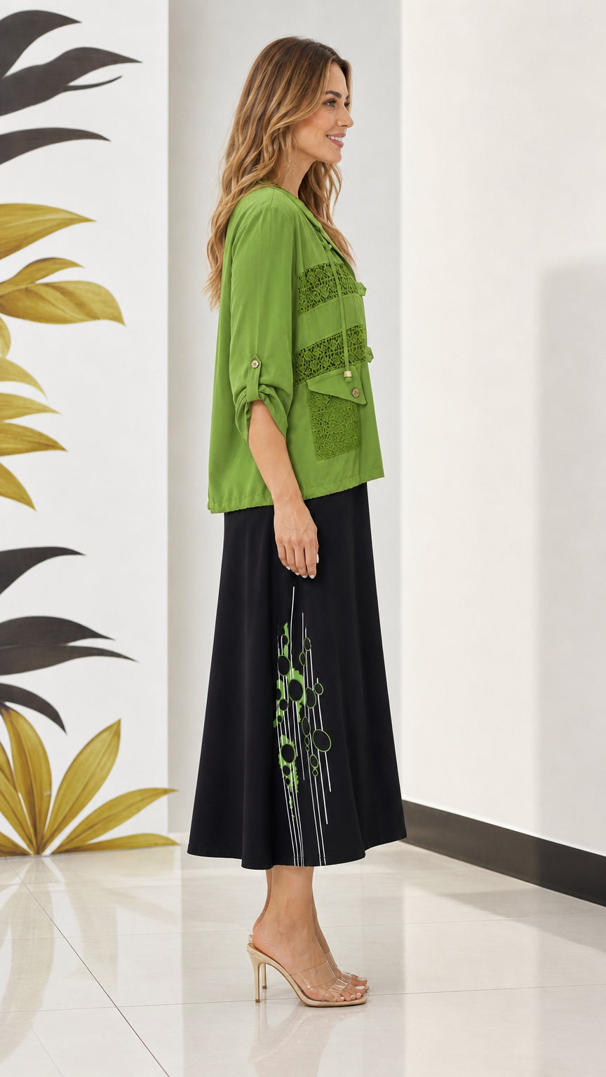 Side angle view of olive green lace-trim jacket paired with printed midi dress