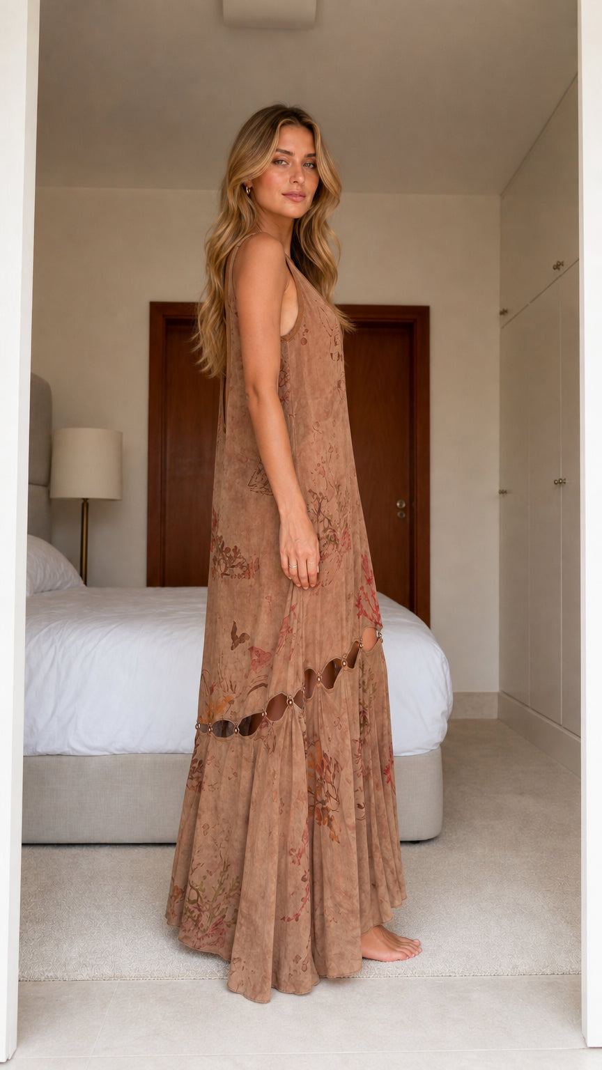 Model wearing brown boho floral print cutout maxi dress, side view