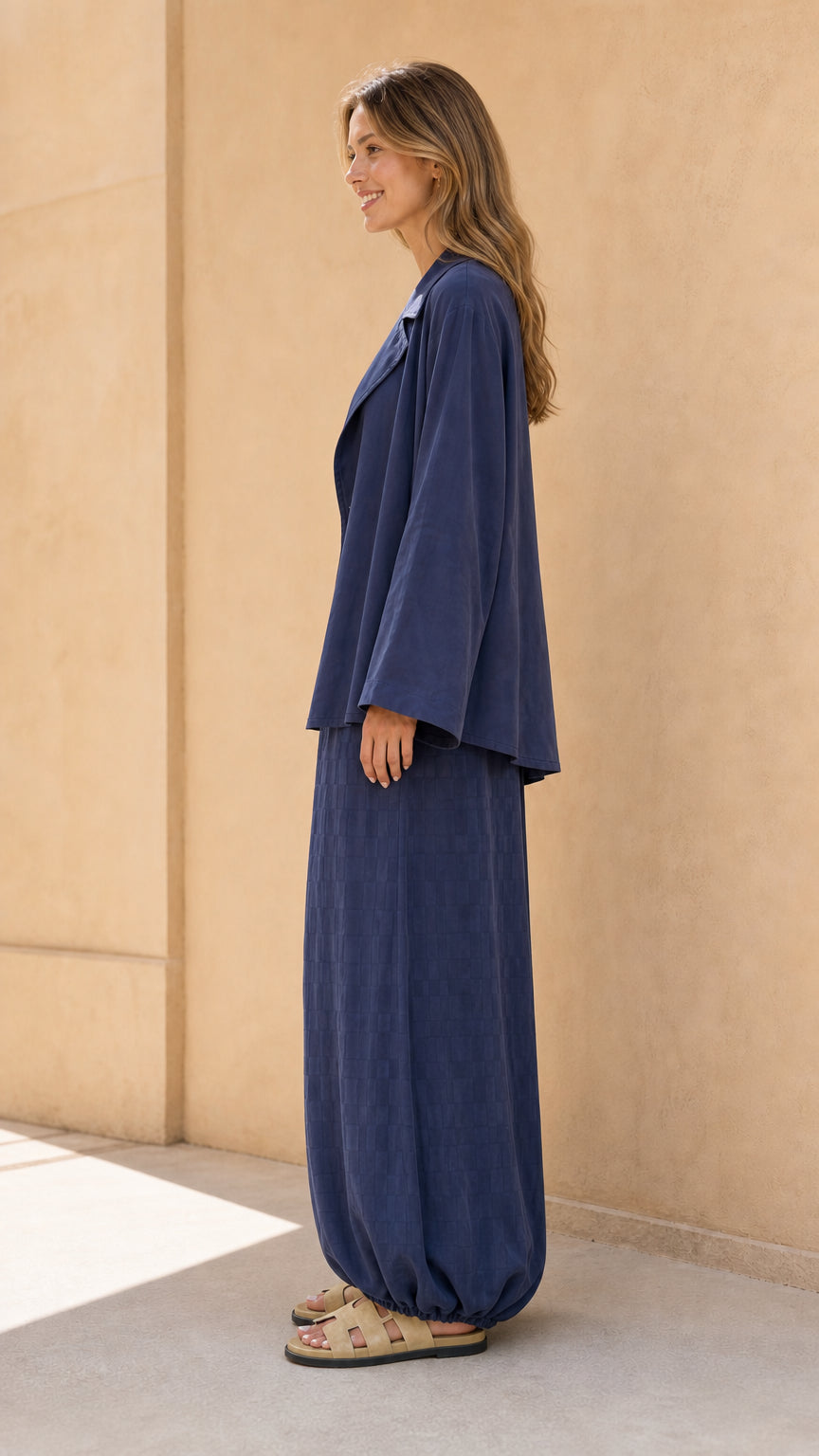 Side profile view of model in navy matching set