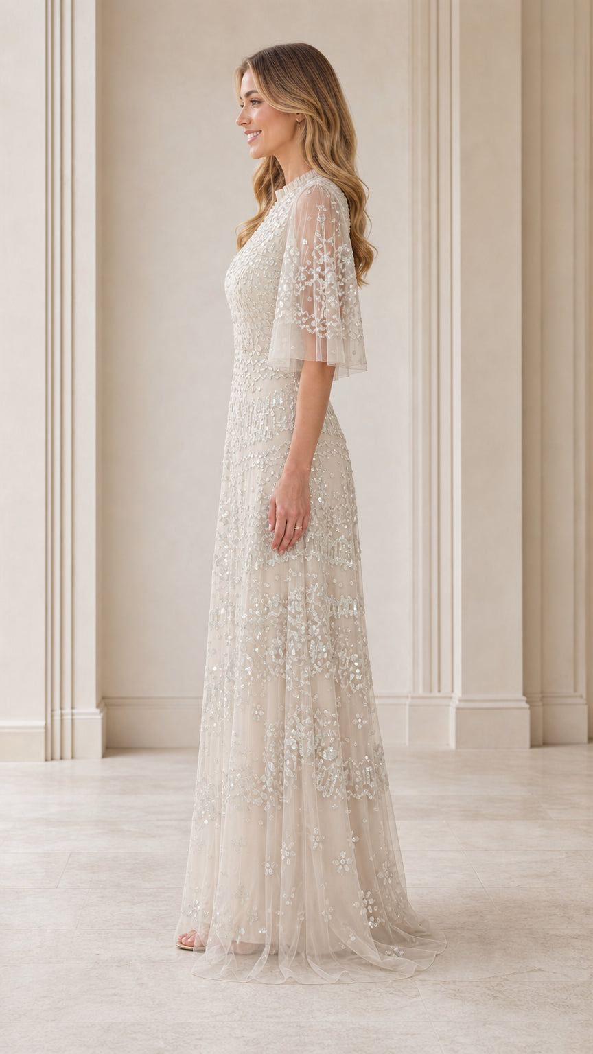 Side profile view of model in champagne floor-length gown