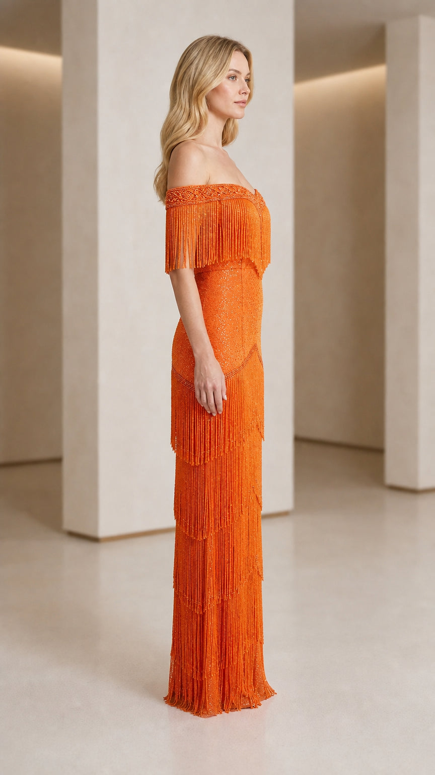 Side profile of woman in orange fringe maxi dress