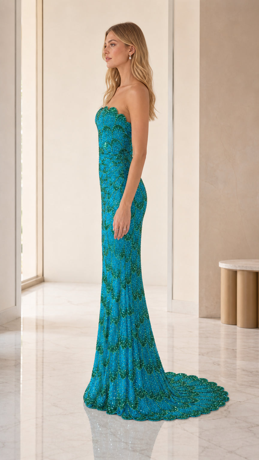 Side profile view of teal sequin mermaid gown with train