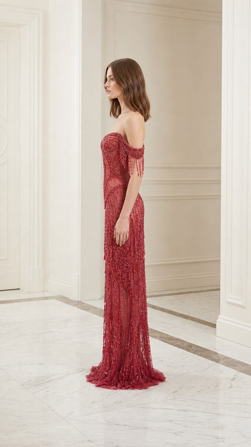 Model wearing red off-shoulder beaded evening gown, side view