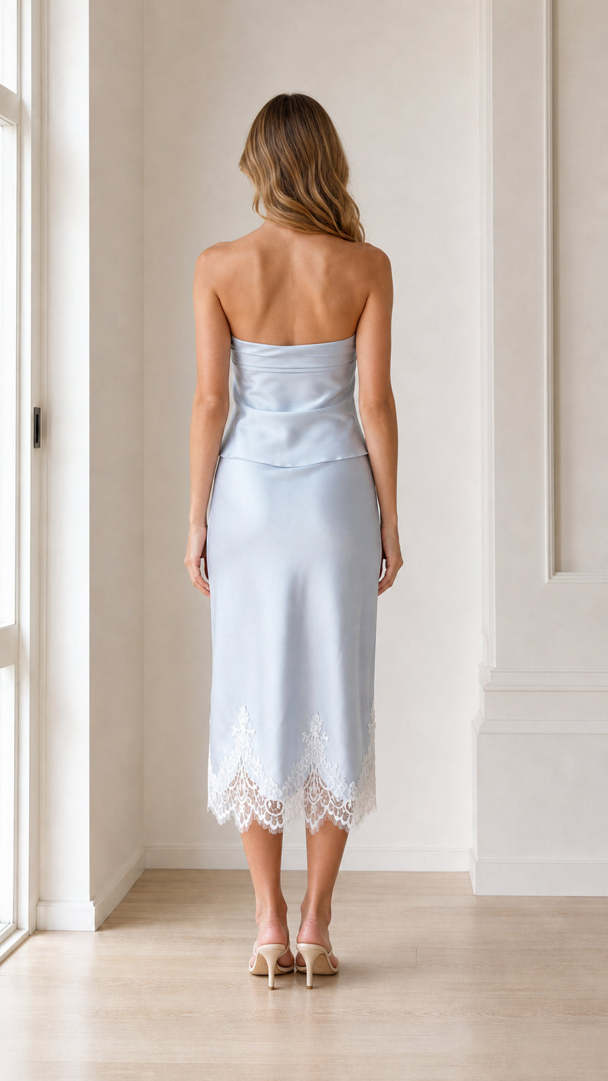 Back view of woman wearing light blue strapless satin midi dress