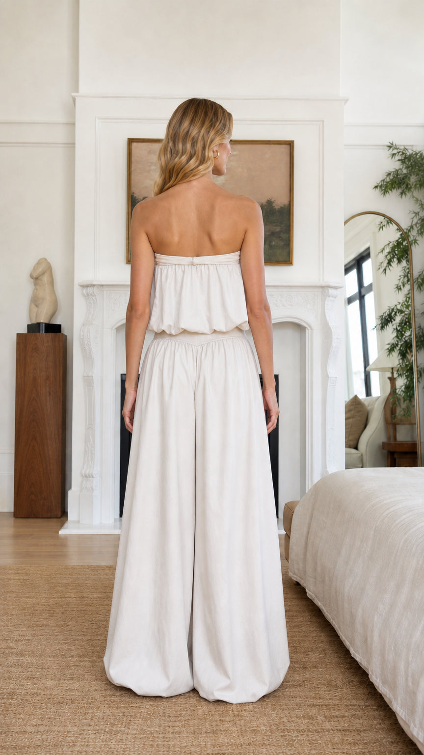 Back view of model in beige strapless top and pants