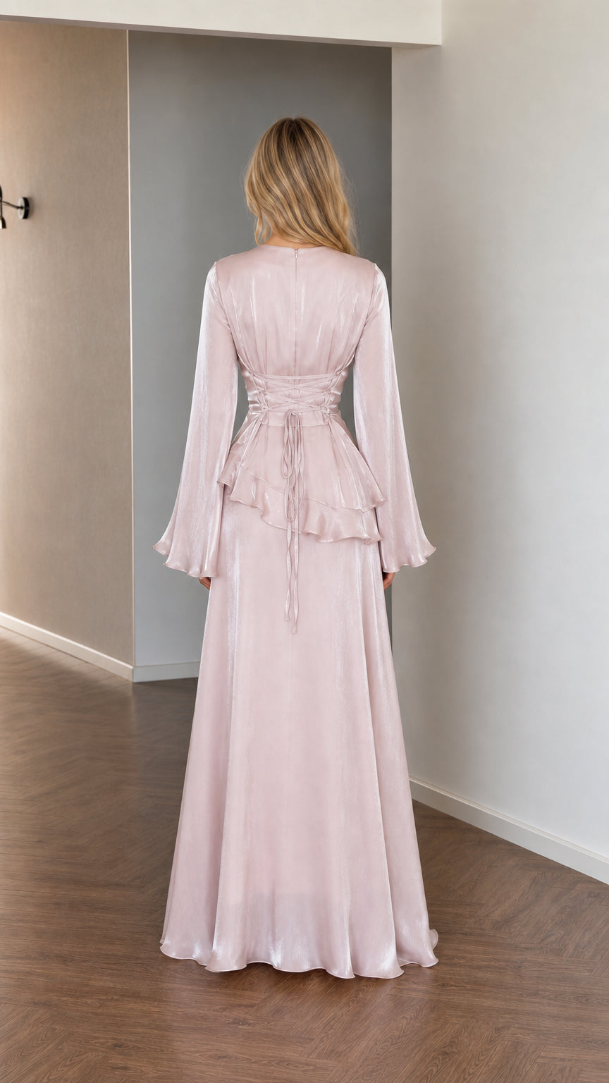 Back view of model showing lace-up details on pink satin dress