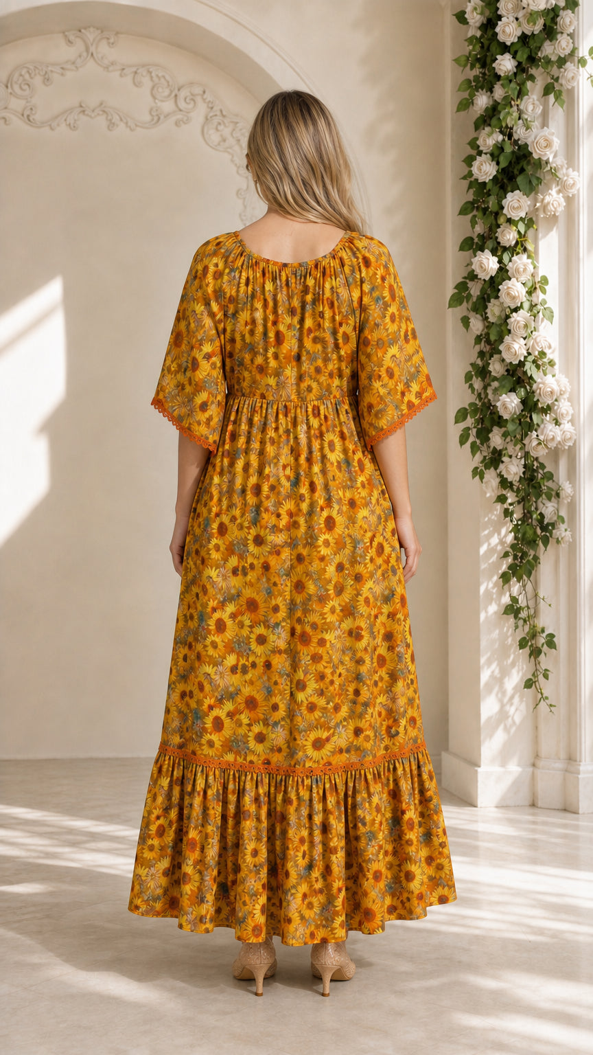 Back view of model wearing mustard yellow floral maxi dress with gathered waist