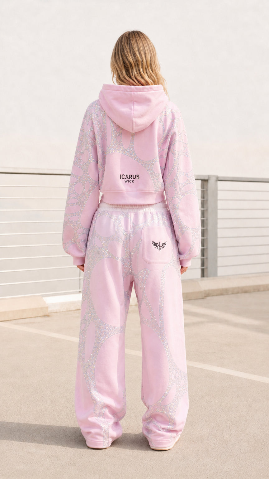 Back view of model wearing pink embellished tracksuit set