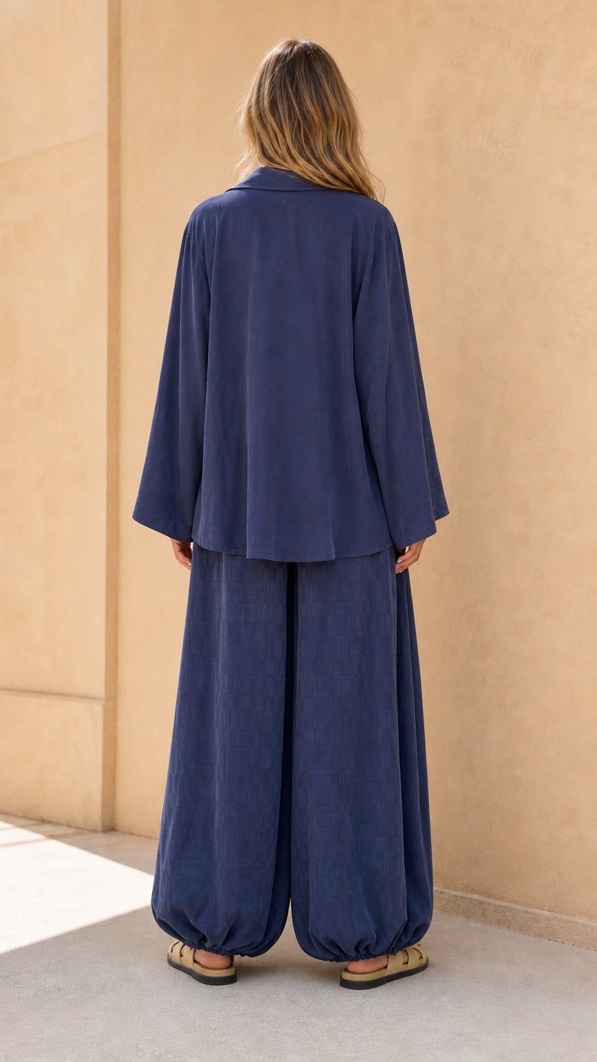 Back view of model in navy matching set