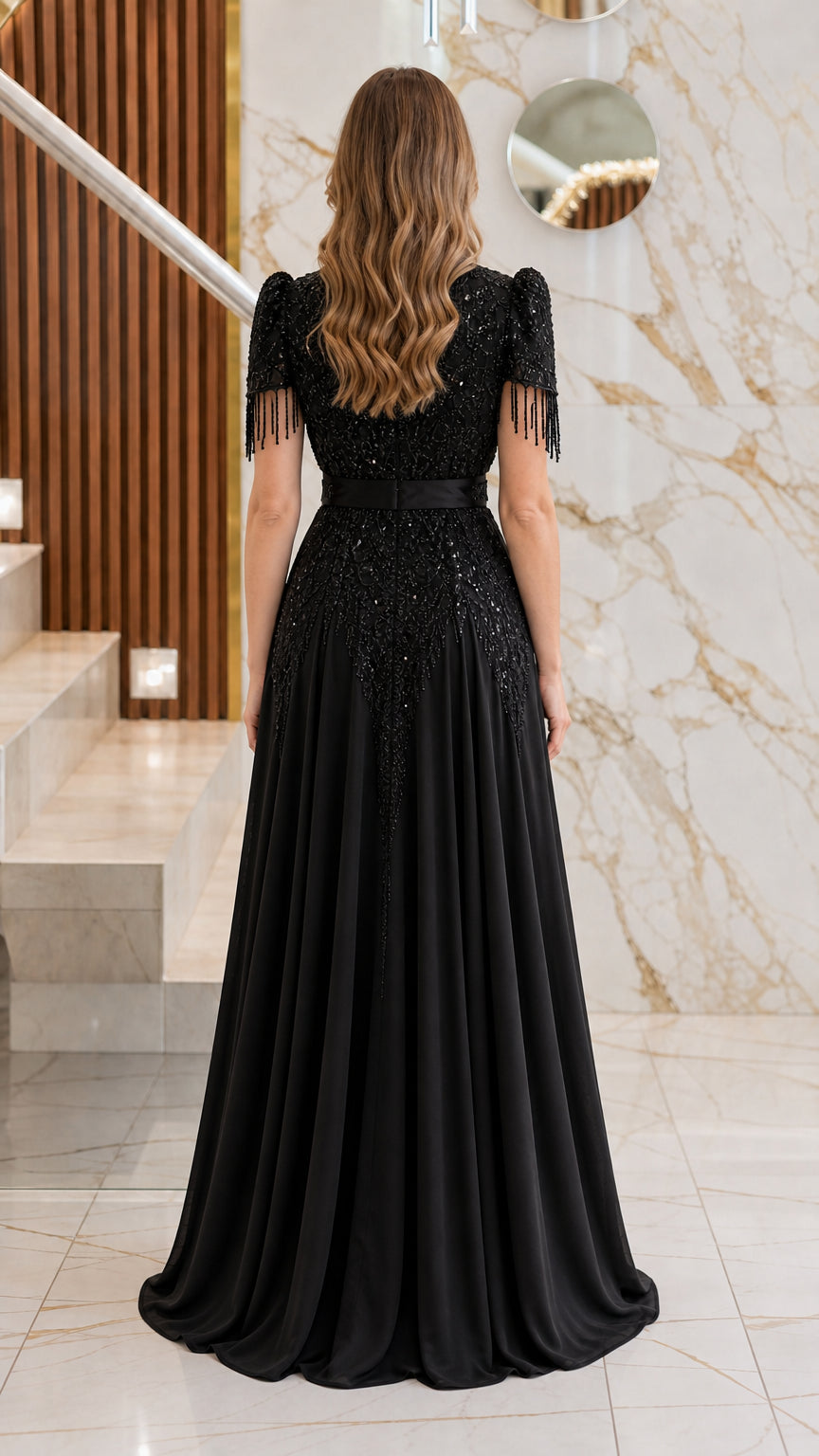 Back view of the black formal evening dress highlighting the fitted bodice and floor-length skirt