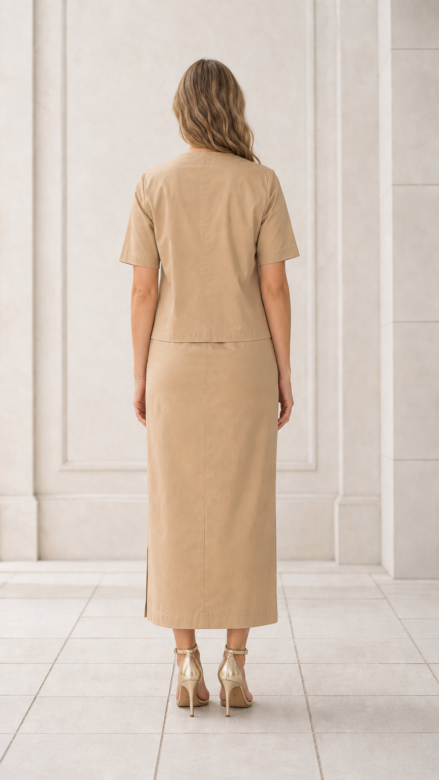 Back full view of woman wearing khaki short sleeve blouse and matching maxi skirt