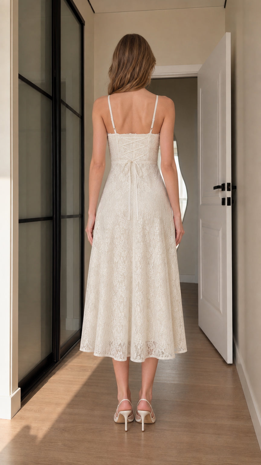 Back view of ivory lace midi dress featuring slim straps and fitted bodice