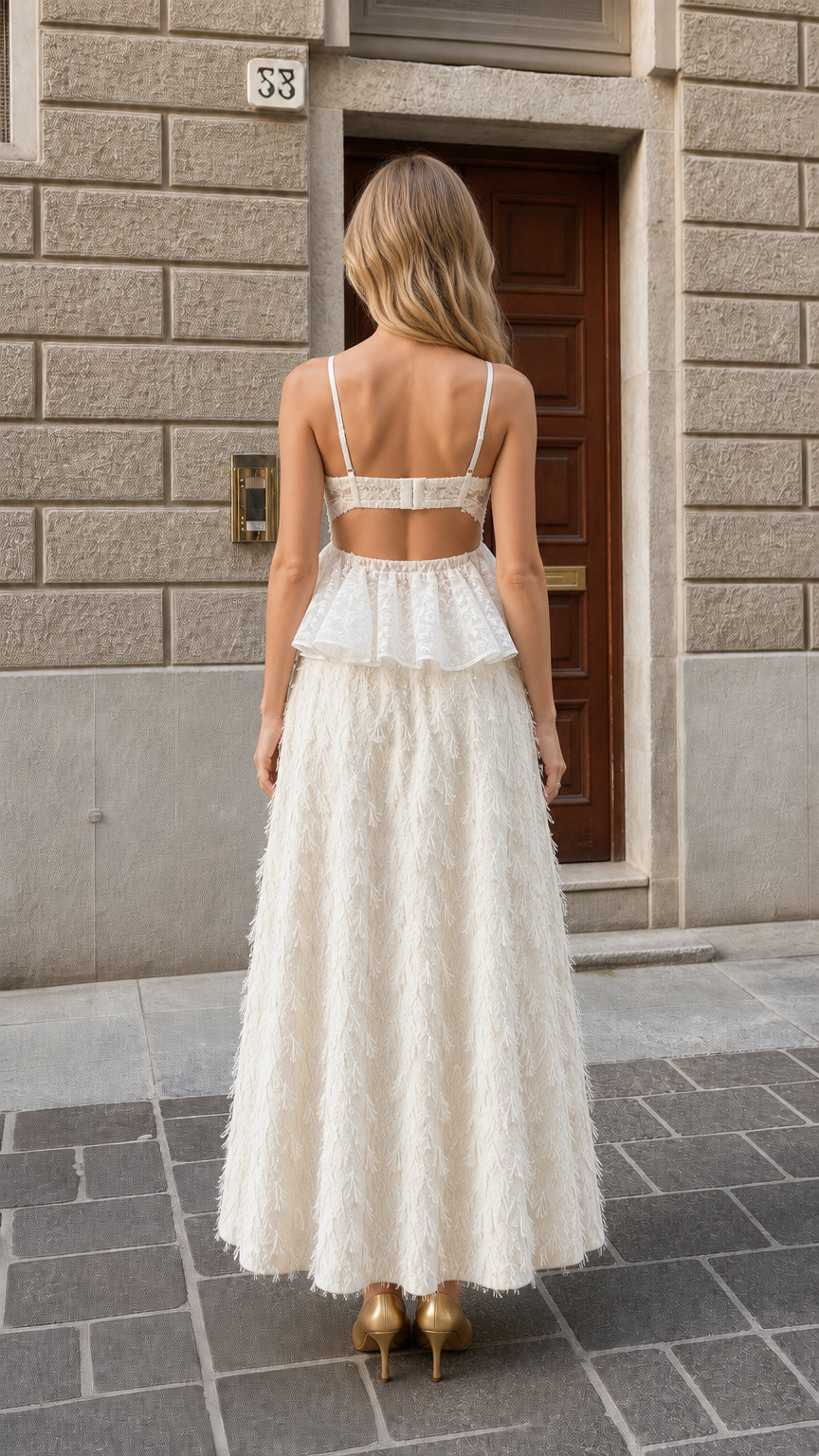 Back view showing cutout back detail on ivory white corset maxi gown
