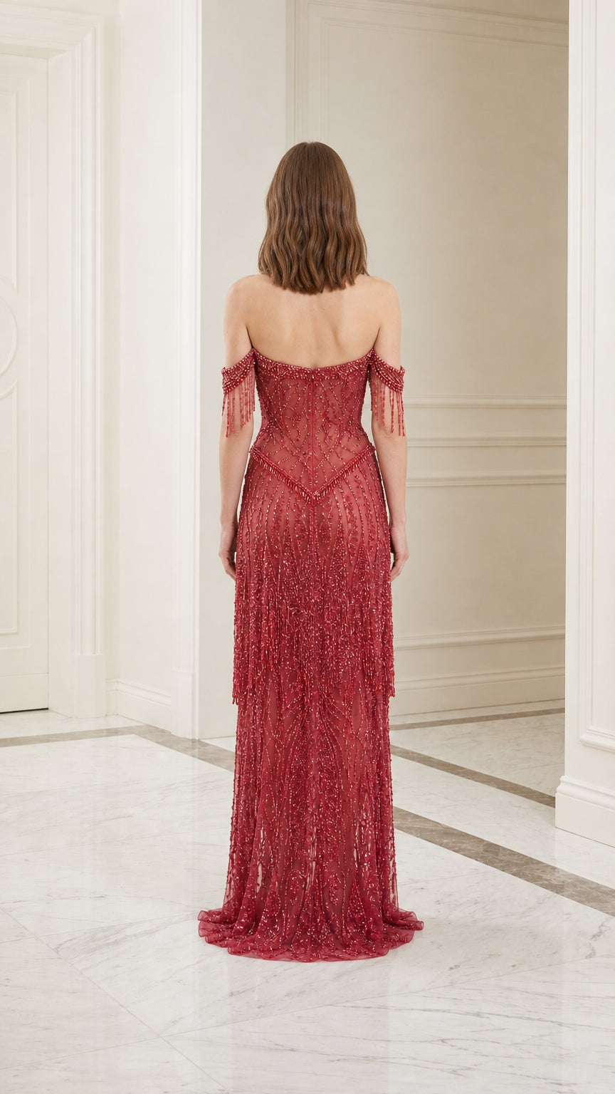 Model wearing red off-shoulder beaded evening gown, back view