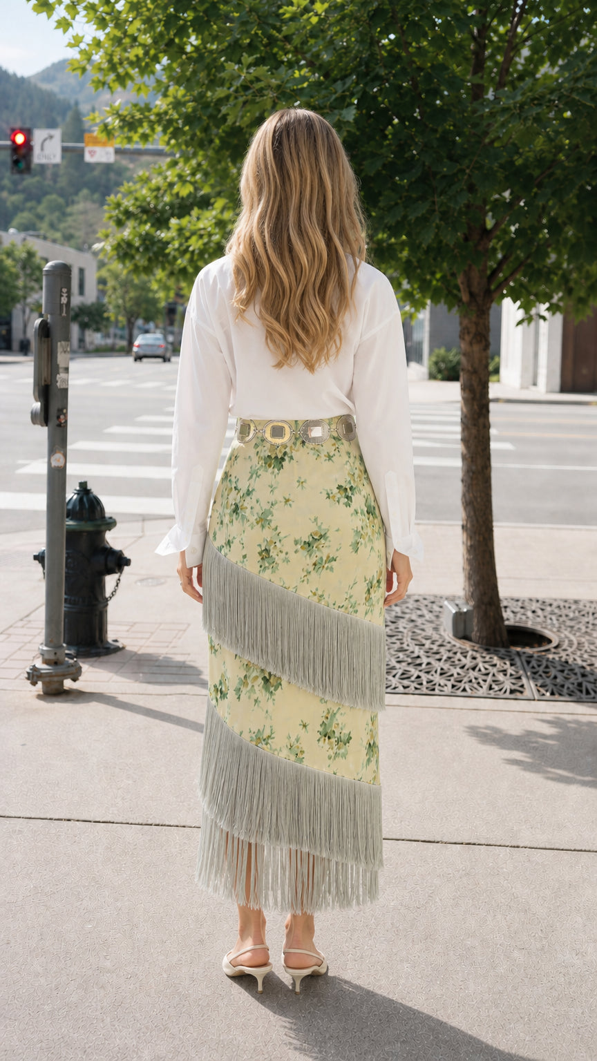 Back view of model showcasing high waist floral midi skirt with tiered fringe