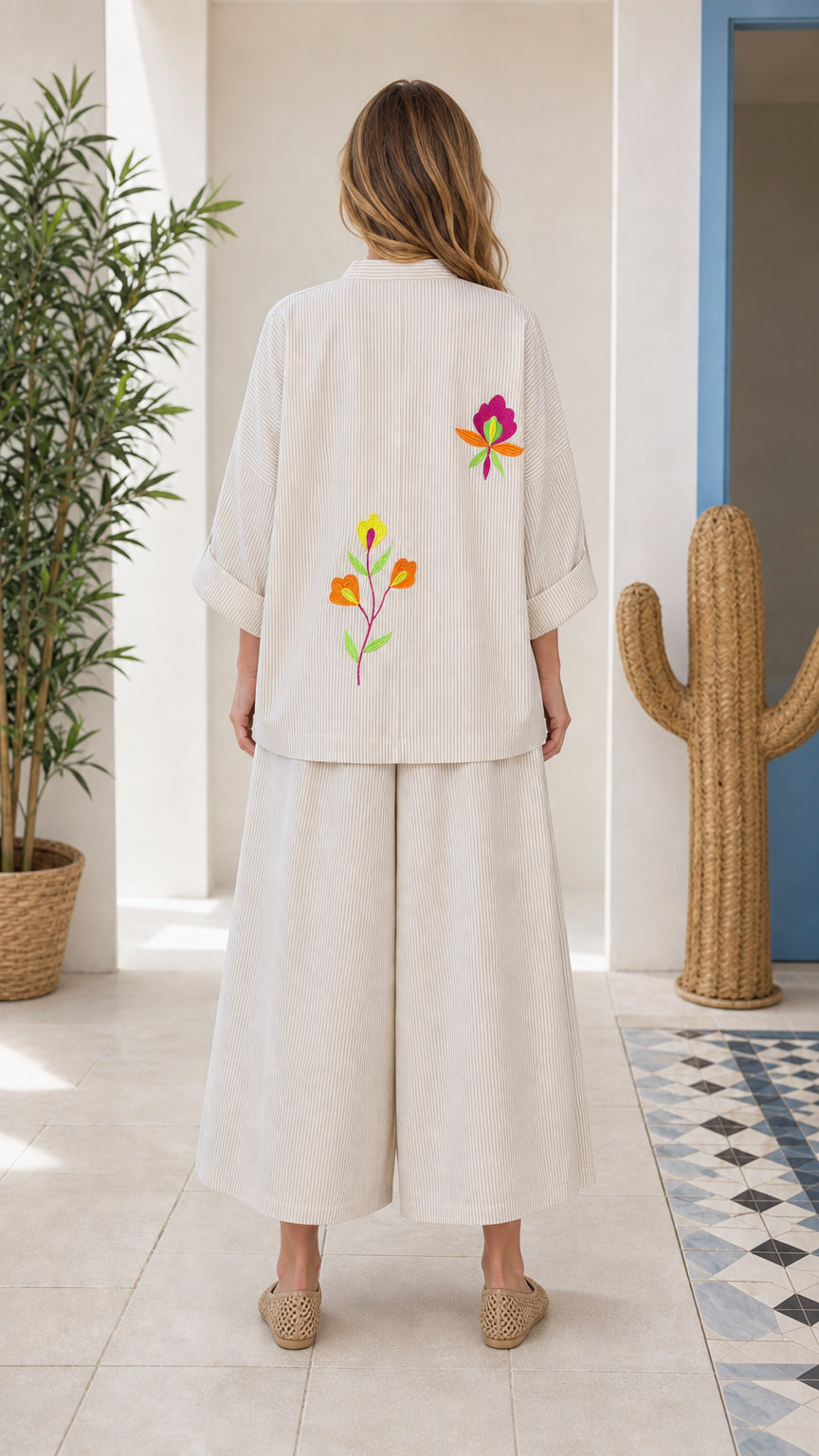 Back view of woman wearing beige embroidered two-piece set