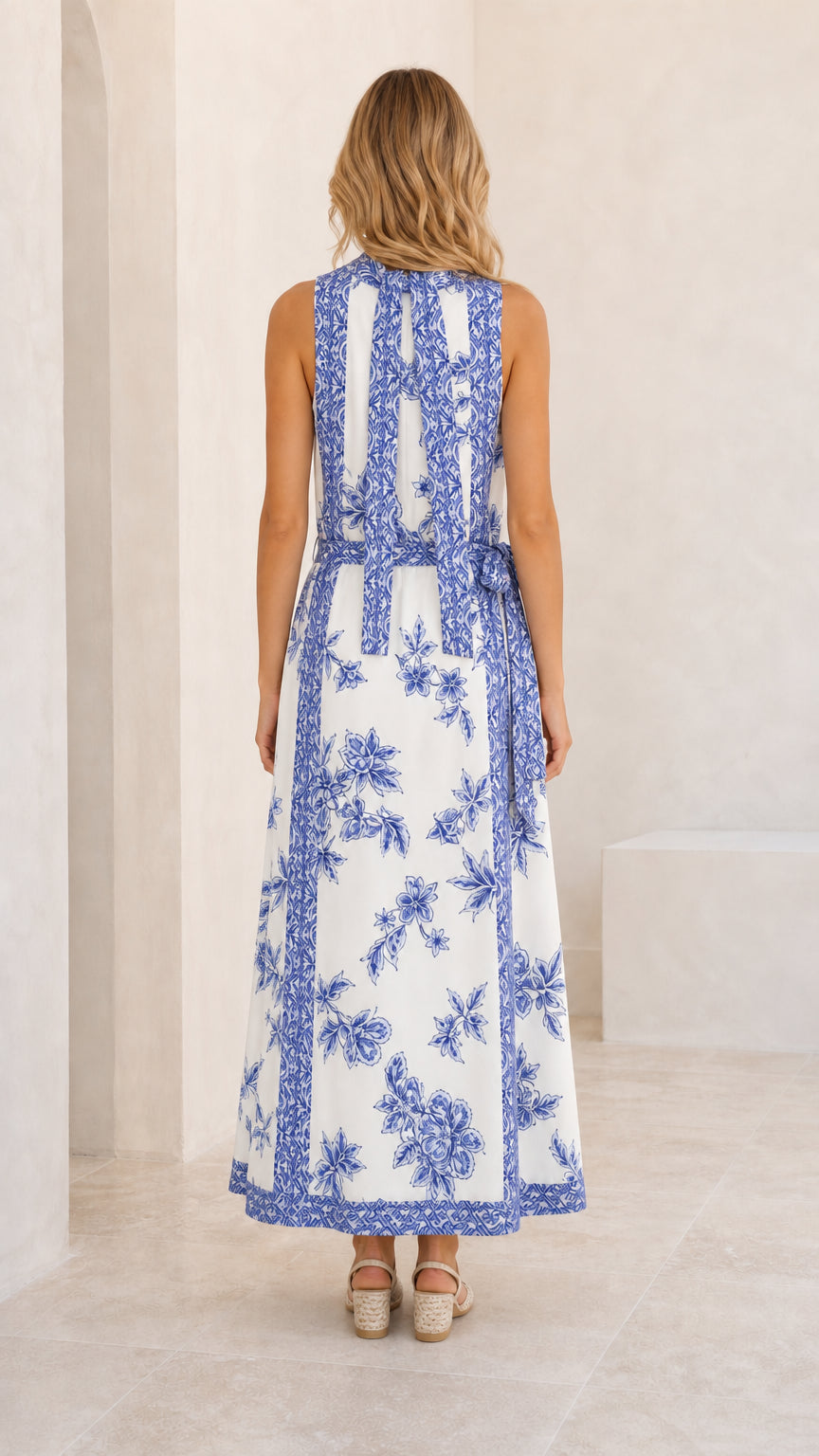 Back view of white floral maxi dress showing detailed neck tie