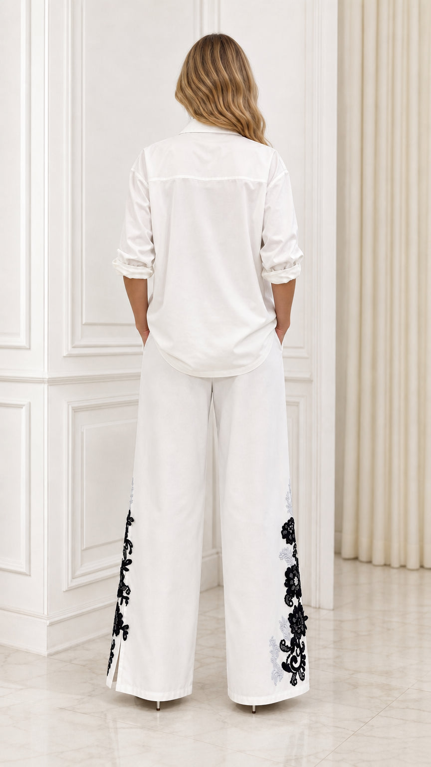 Back view of white embroidered shirt and wide-leg trousers