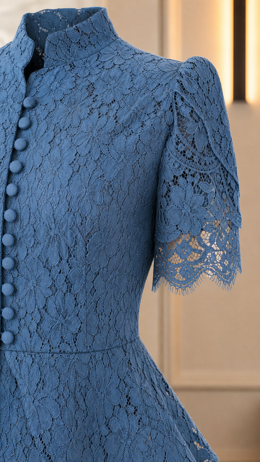 Close-up detail of blue lace stand collar, buttons, and puff sleeve