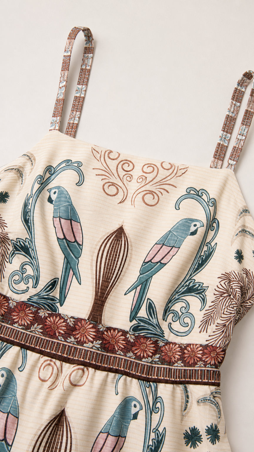 Close-up detail of upper bodice, straps, and tropical parrot fabric pattern in Ivory