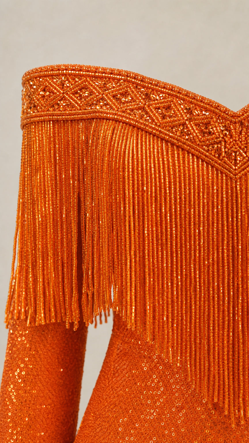 Close-up detail of orange beaded neckline and fringe trim