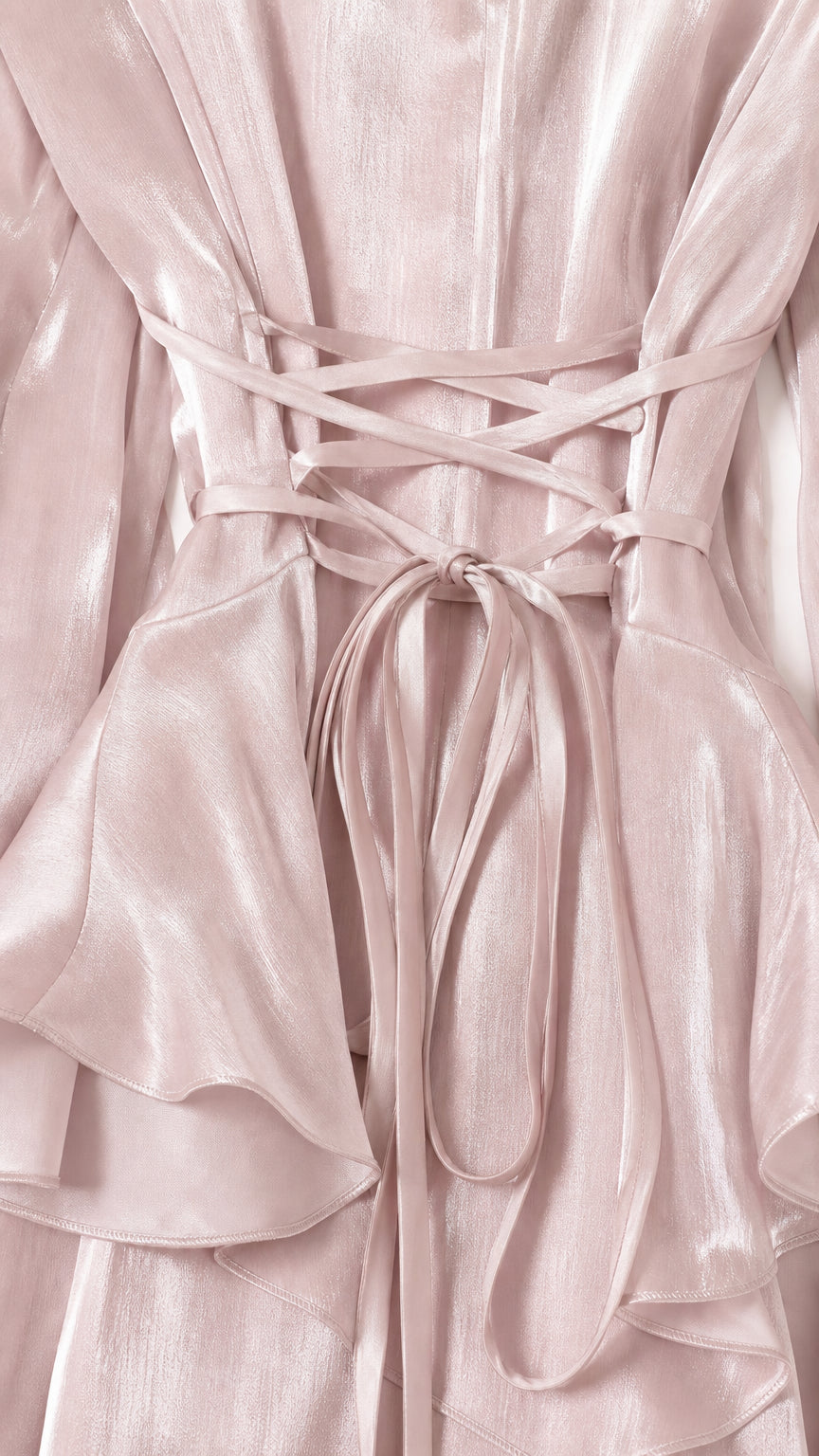 Close-up detail of the lace-up back and ruffled waist on pink dress